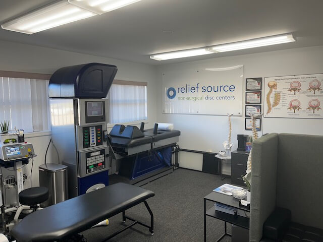 A treatment area at Relief Source showing the spinal decompression equipment and patient area with bed